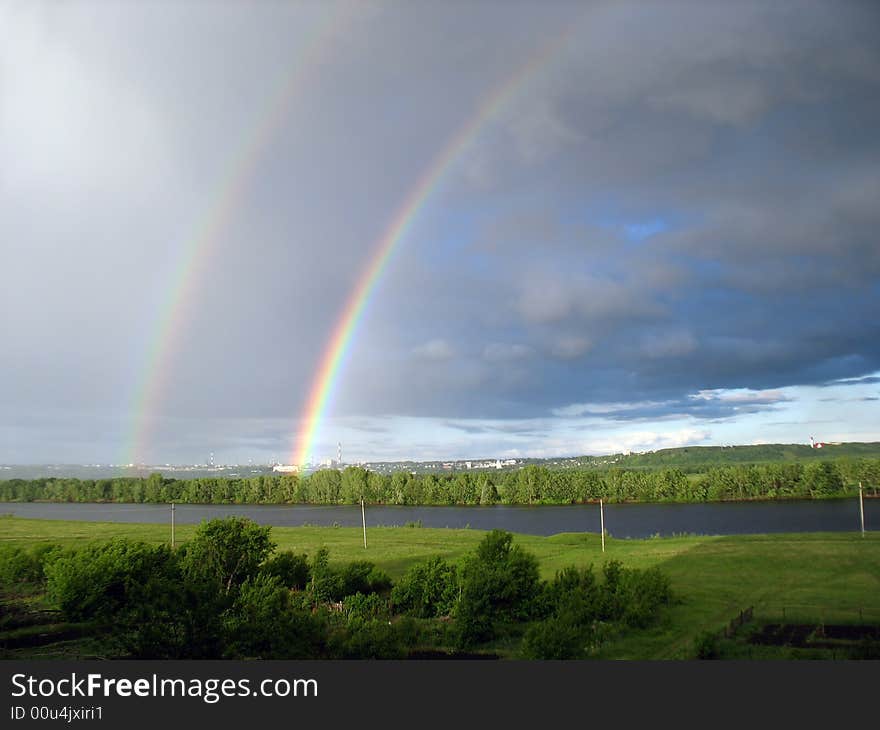 Landscape with rainbow over lake