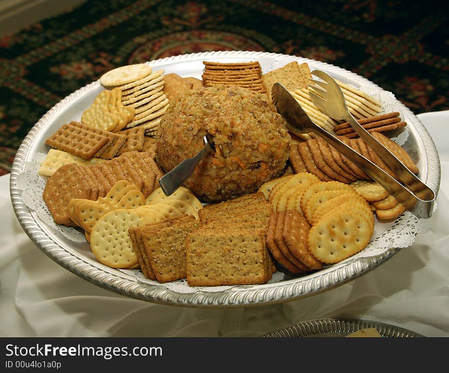 Cracker assortment arranged on serving tray with tongs