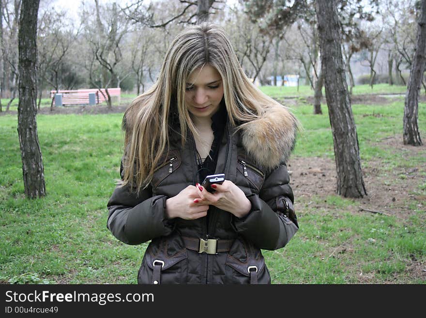 Pretty girl looking in her mobile phone. Pretty girl looking in her mobile phone