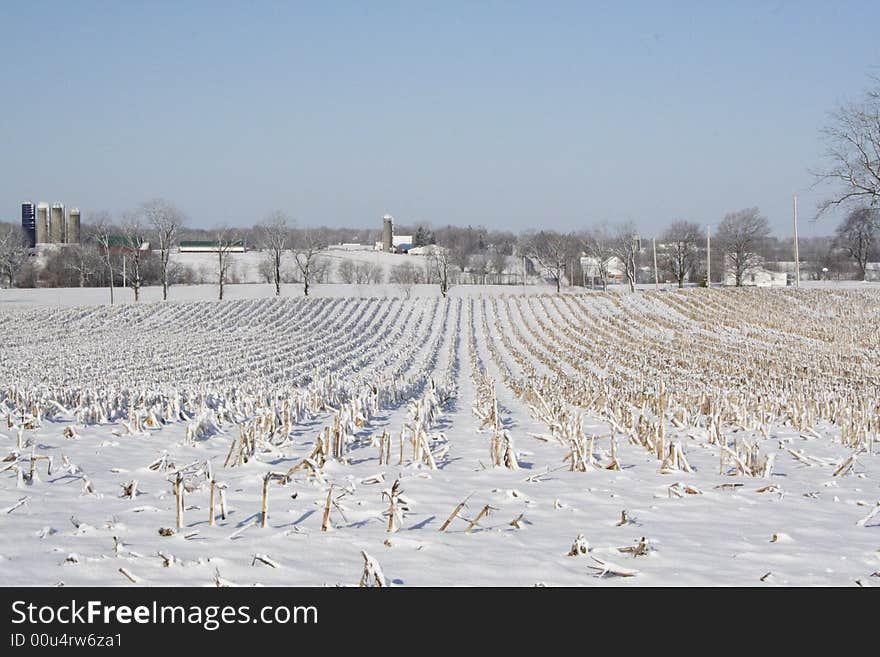 Vista of farms with barns, houses, fields on a cloudless winter day after a fresh snowfall. Vista of farms with barns, houses, fields on a cloudless winter day after a fresh snowfall.