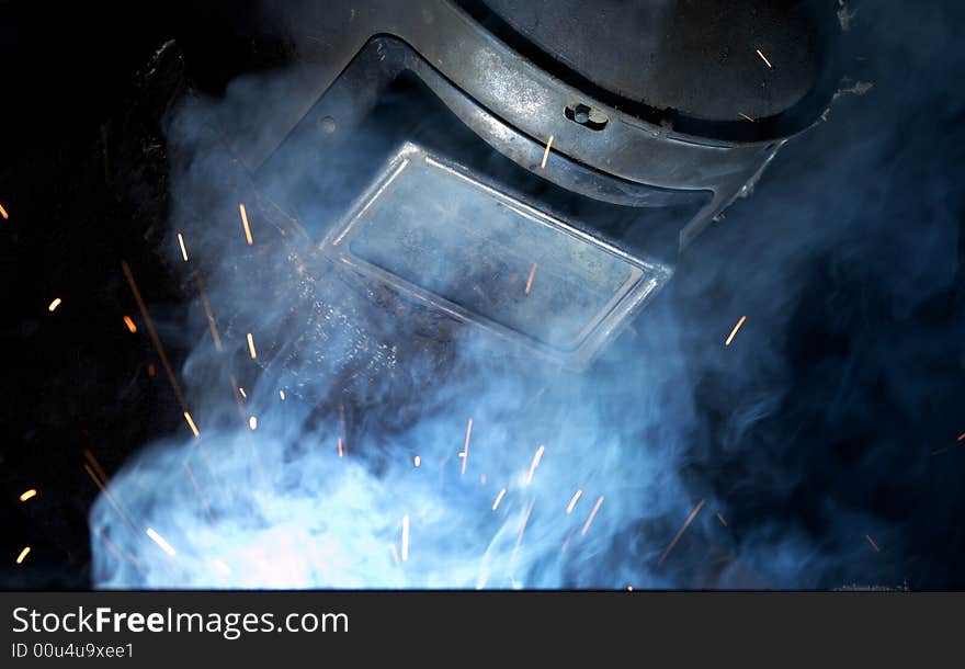 A welder working at shipyard at night. A welder working at shipyard at night