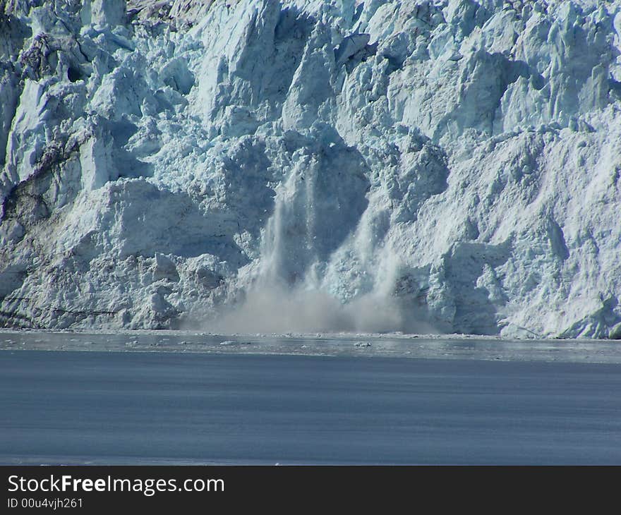 Ice calving off of Hubbard Glacier into the bay.  Taken from Disenchantment Bay  off the Alaska coast. Ice calving off of Hubbard Glacier into the bay.  Taken from Disenchantment Bay  off the Alaska coast.