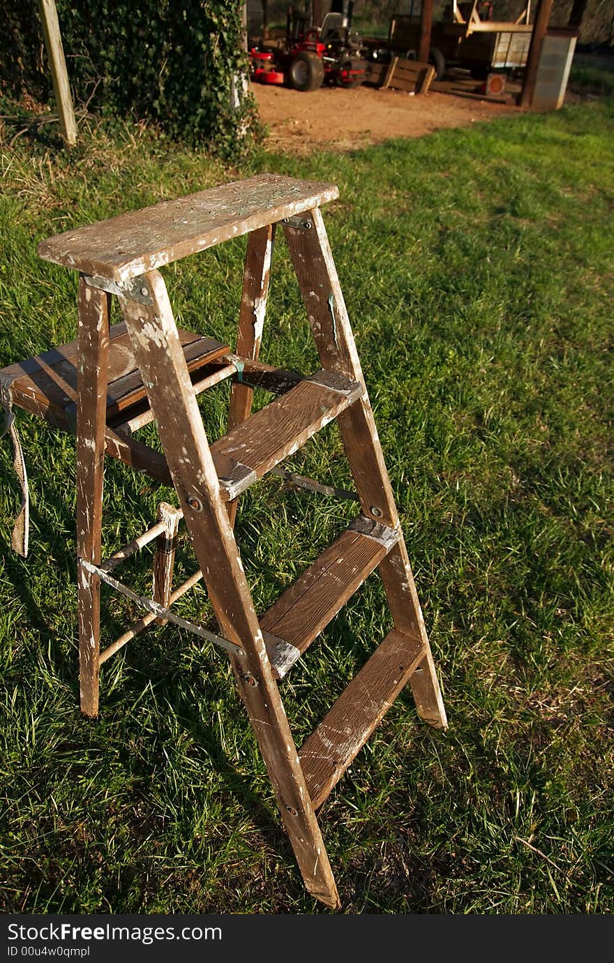 Wooden ladder on grass before barn