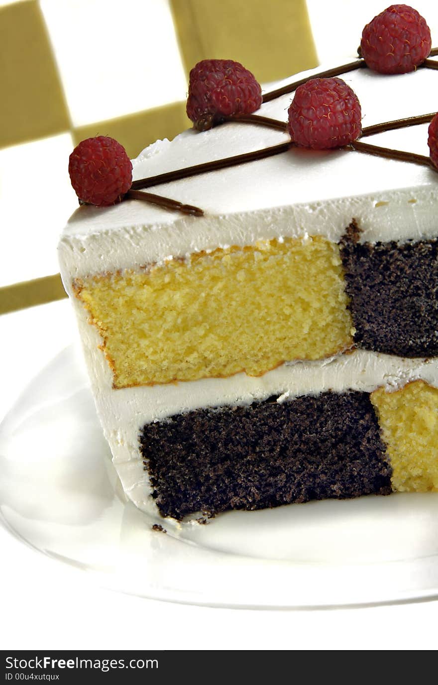 Checkerboard Cake with Raspberries on a white background.