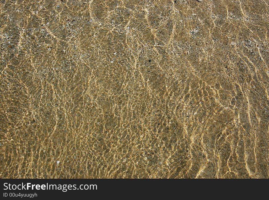 Little Sea Wave Ebbing On A Sand Beach