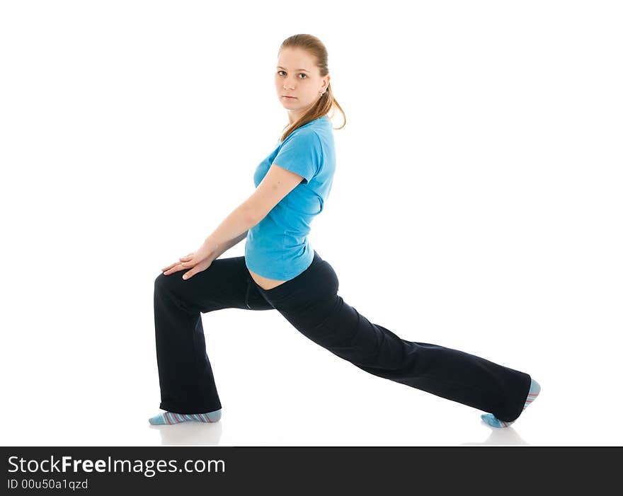 The beautiful young woman doing yoga exercise isolated on a white background. The beautiful young woman doing yoga exercise isolated on a white background