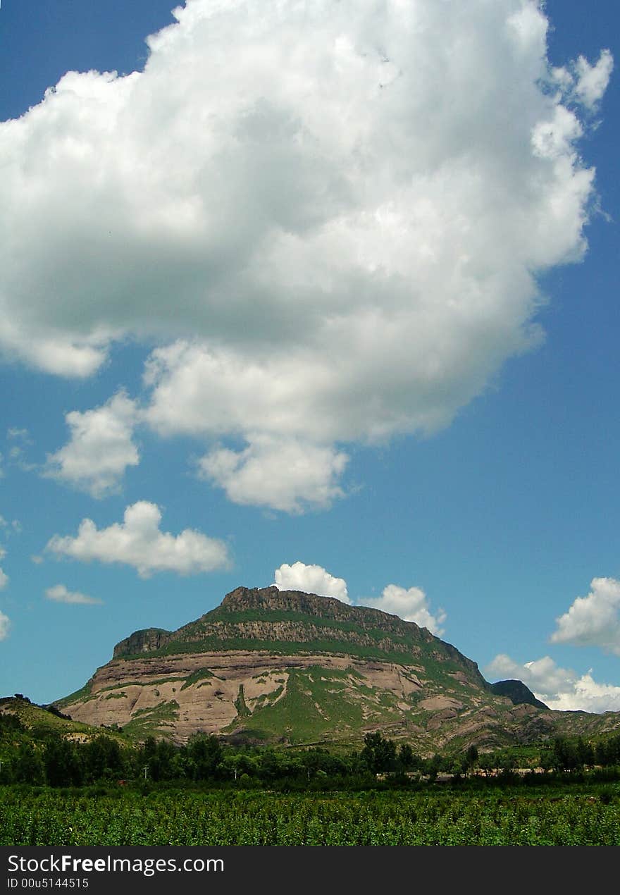 Magnificent mountain range under the blue sky and white cloud