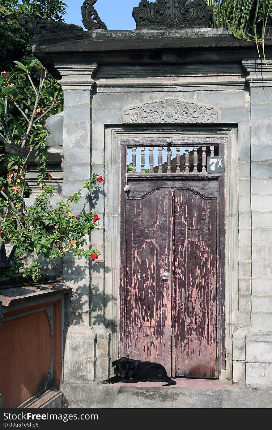 An old door leading to a private compound in Kerobokan, Bali. An old door leading to a private compound in Kerobokan, Bali