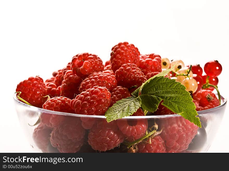 Raspberry and currant on the glassy bowl