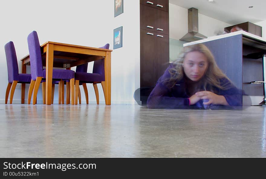 Long-exposure photograph featuring the ghostly image of a woman crouched on the floor of a modern townhouse (Adelaide, Australia). Long-exposure photograph featuring the ghostly image of a woman crouched on the floor of a modern townhouse (Adelaide, Australia).