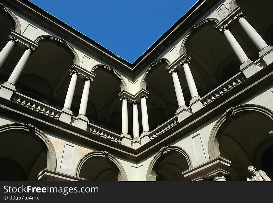 Historic building with white stones and sculpture under blue sky. Historic building with white stones and sculpture under blue sky