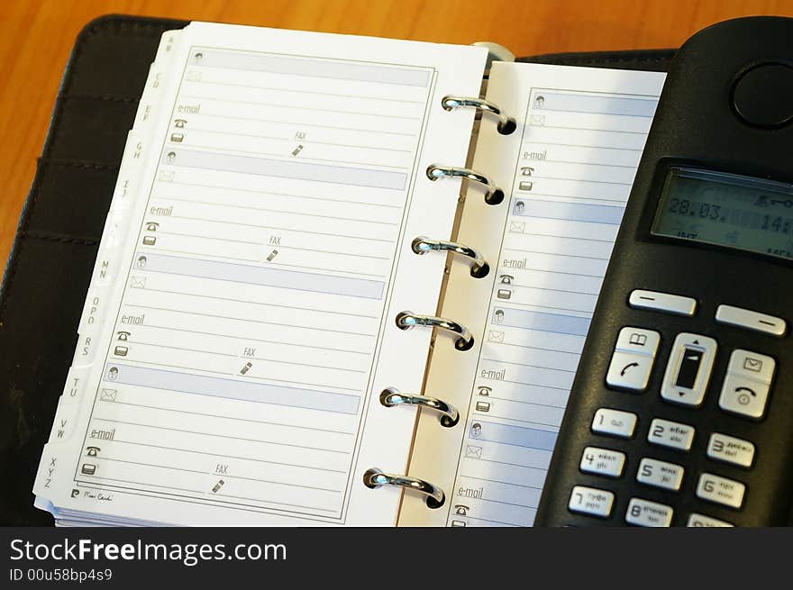 Notebook And A Black  Telephone