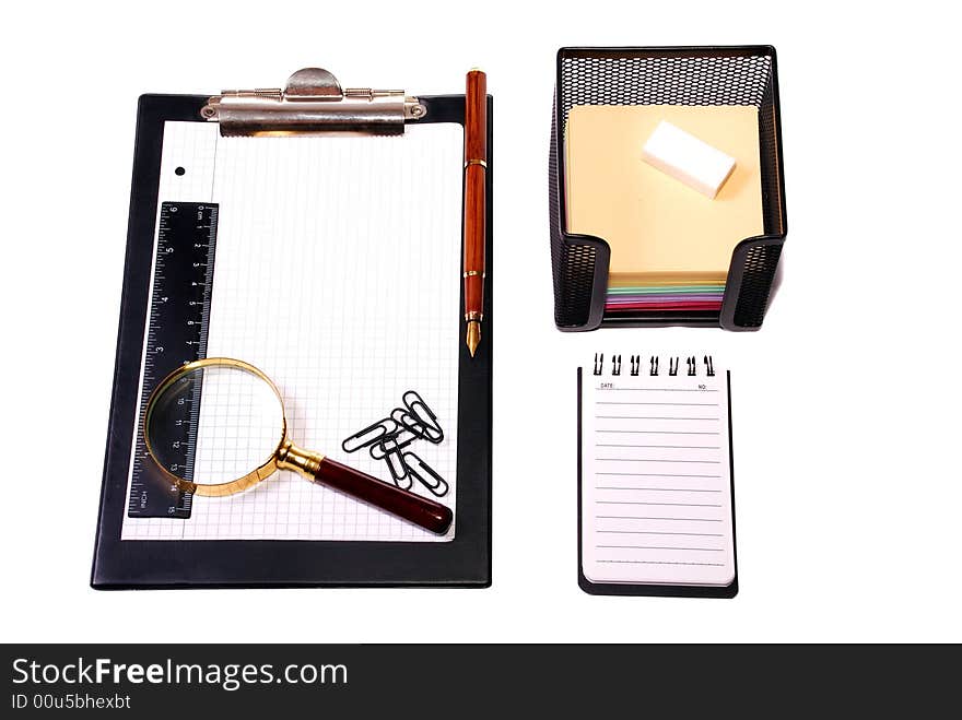 Office tools Magnifier, paper clips, a notebook, pencils