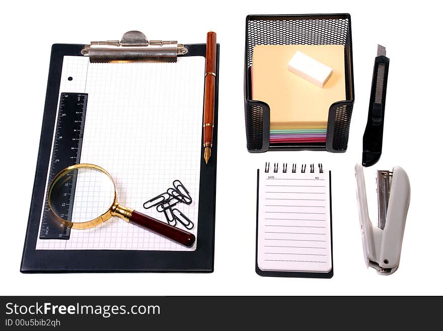 Office tools Magnifier, paper clips, a notebook, pencils