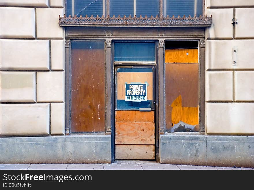 A boarded up unoccupied building. A boarded up unoccupied building