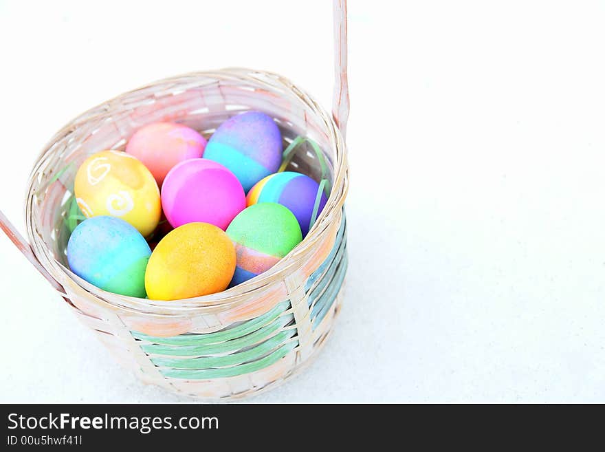 Easter basket filled with colourful eggs. Easter basket filled with colourful eggs