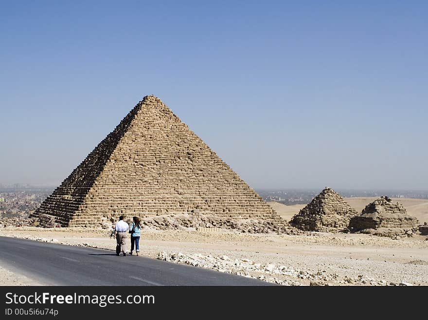 People go on road near pyramids