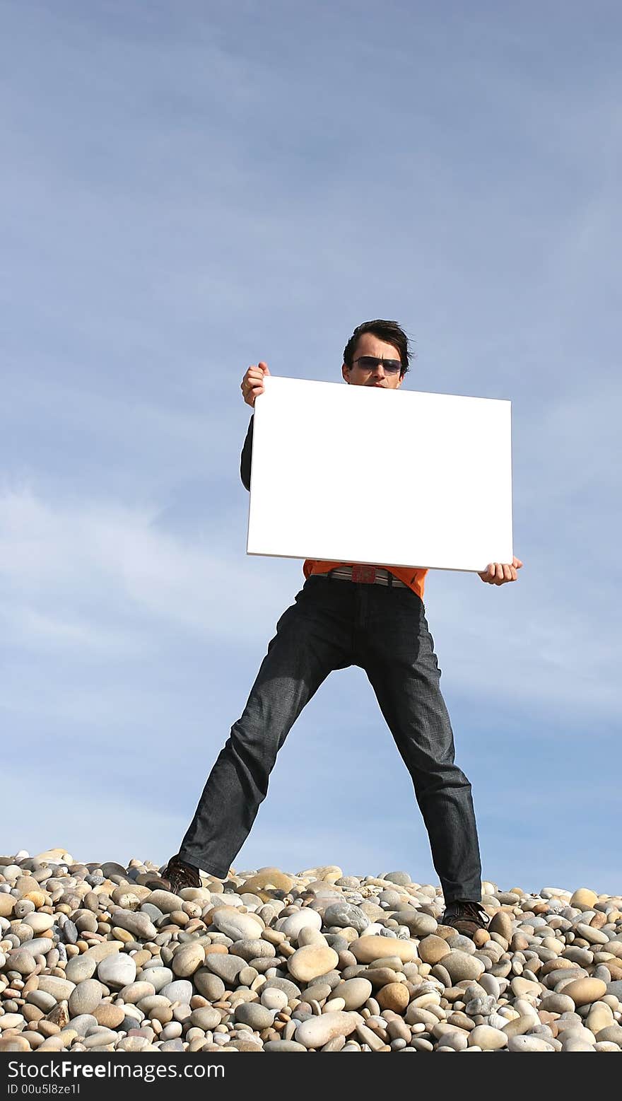 Young Man Holding White Card at the beach