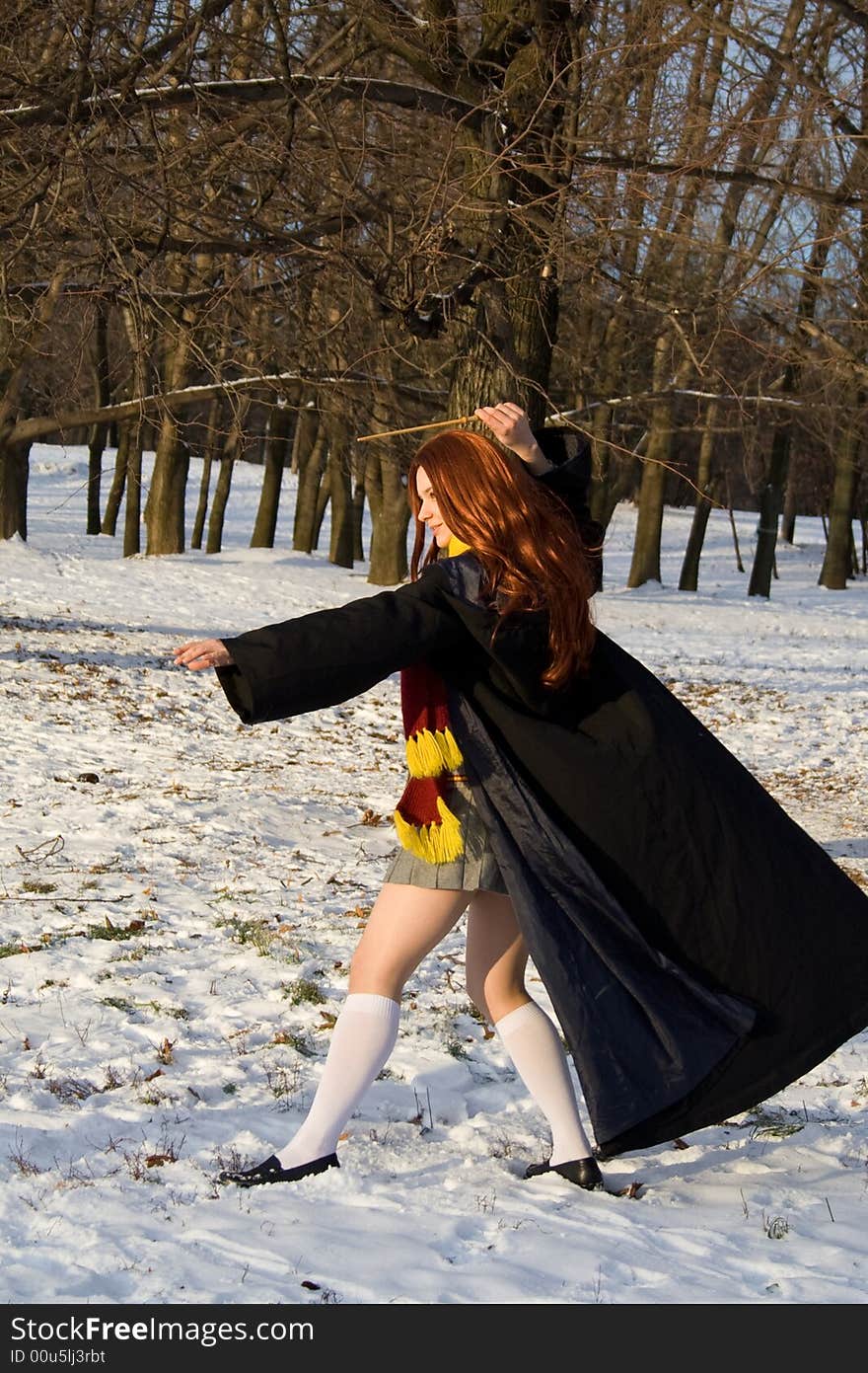 Winter morning: schoolgirl standing near schoolhouse