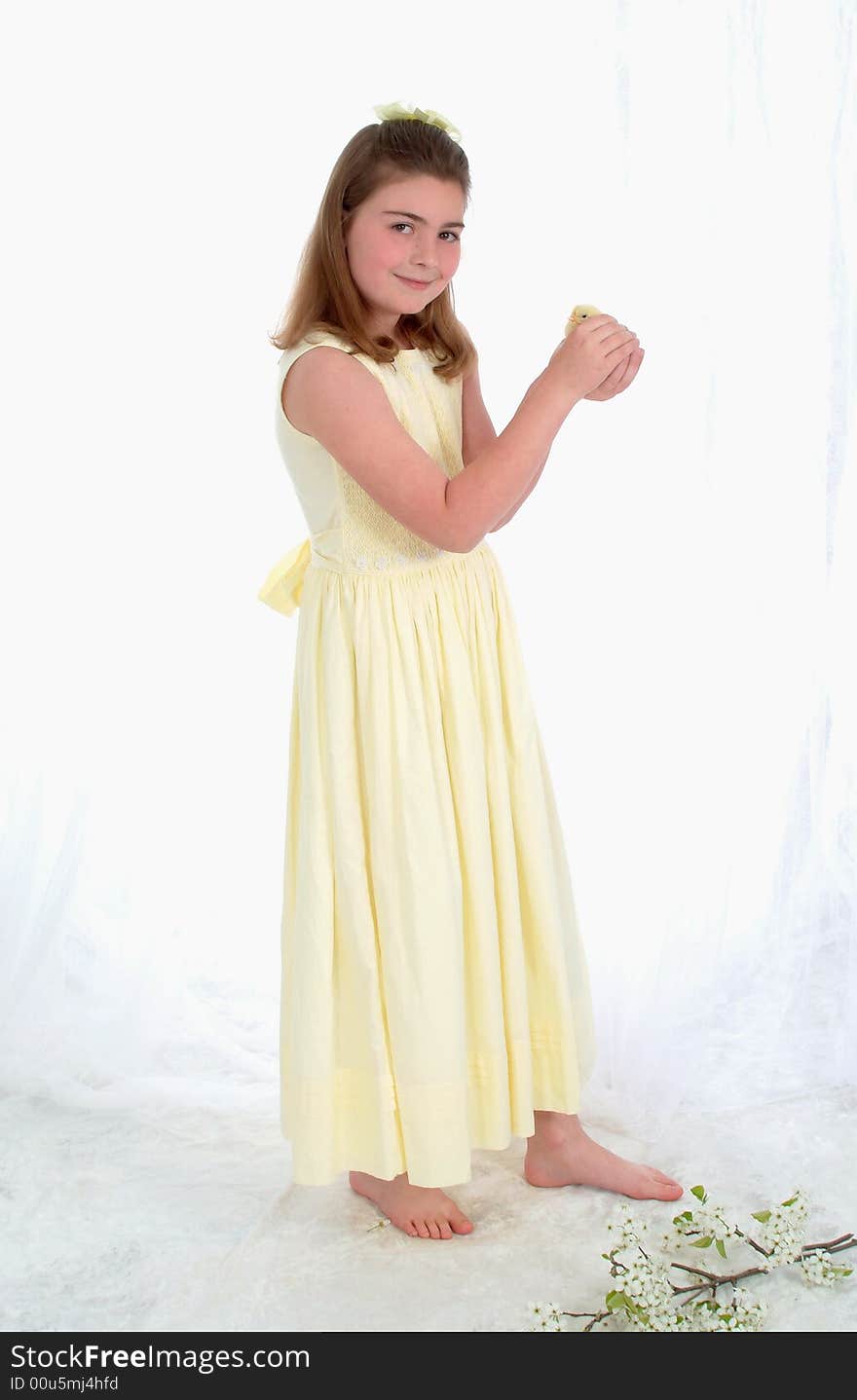 Smiling young girl holding yellow chick. Smiling young girl holding yellow chick