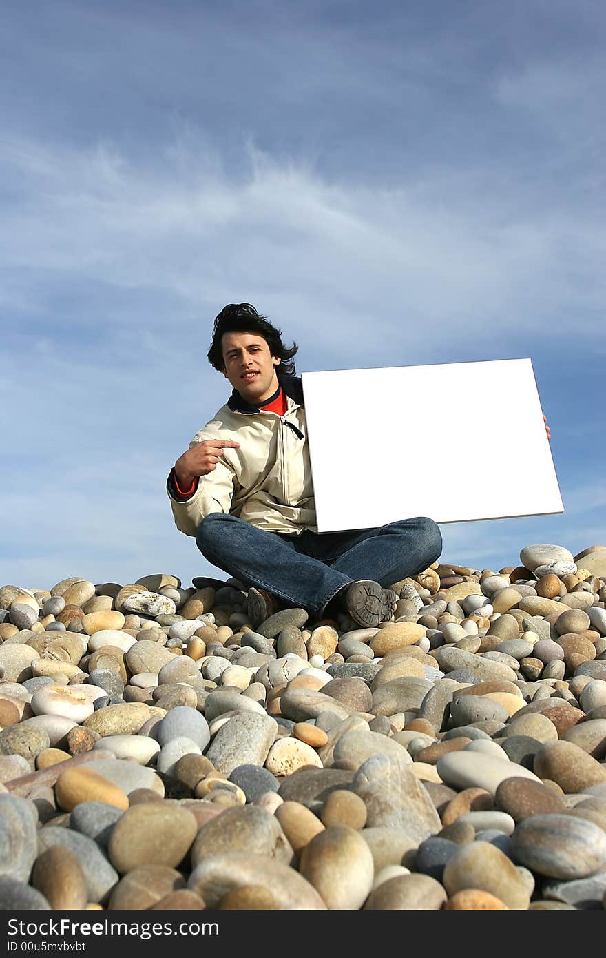 Young Man Holding White Card at the beach