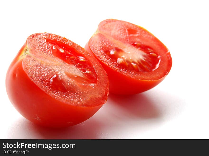 Red tomatos cutted isolated on white. Red tomatos cutted isolated on white