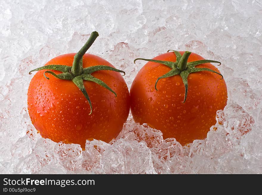 Red ripe tomatoes on bed of cracked ice