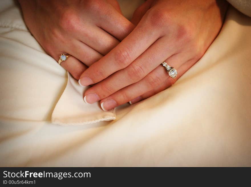 Wedding day Brides hands in her lap