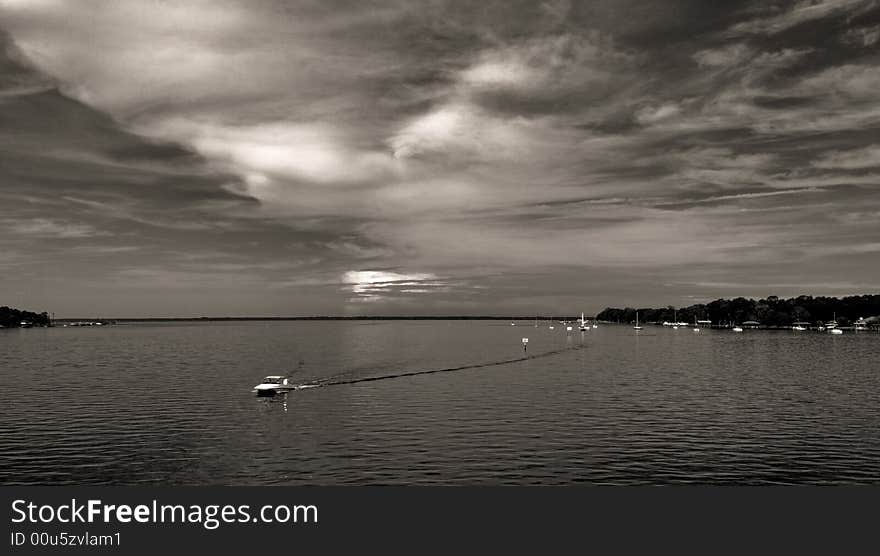 Water and boat with dramatic sky and clouds