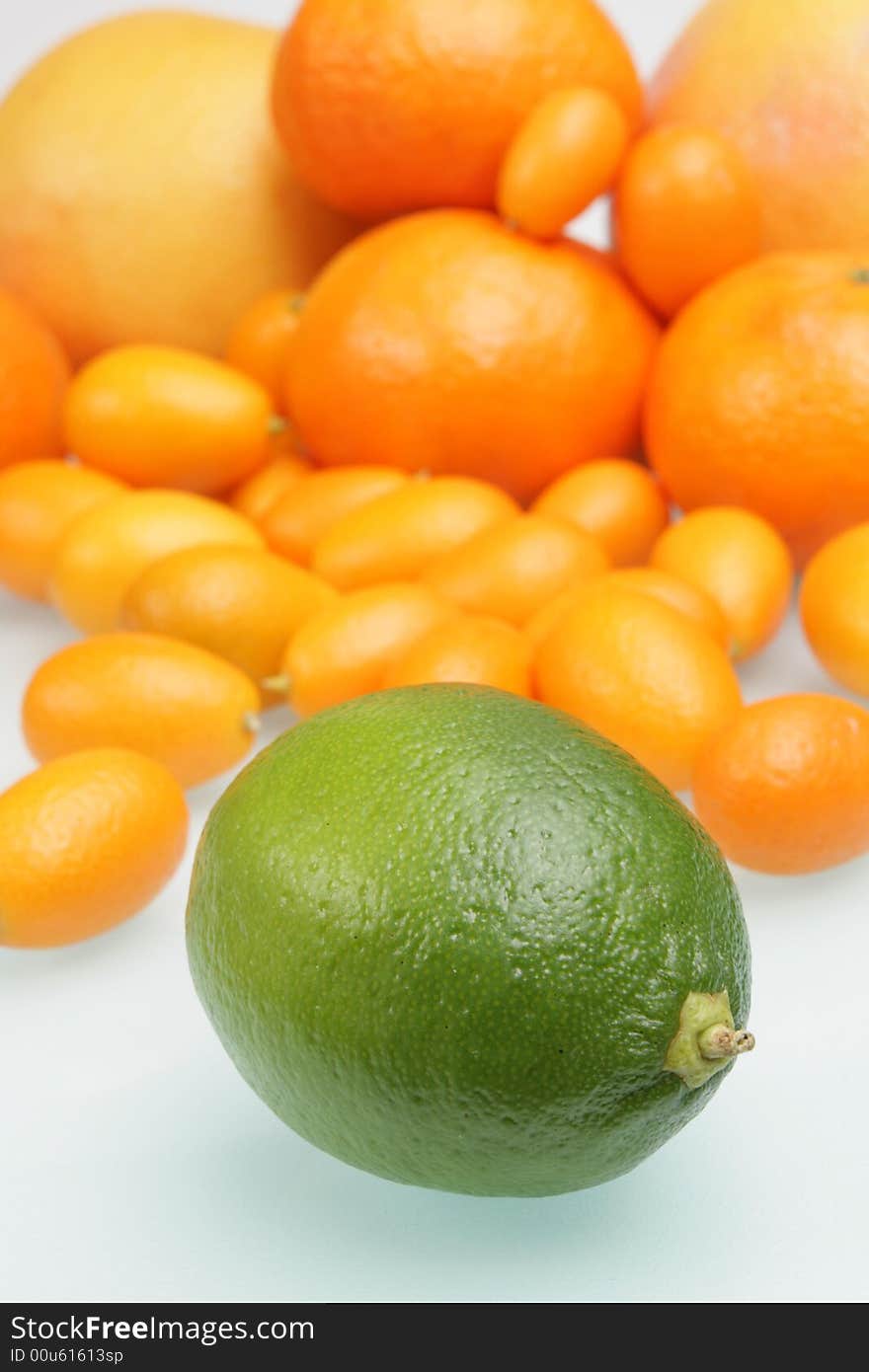 Citrus on a white glass table,focus on a lime