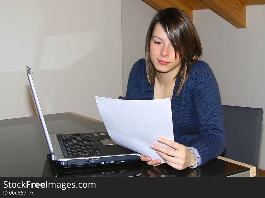 A young woman working at home with notebook