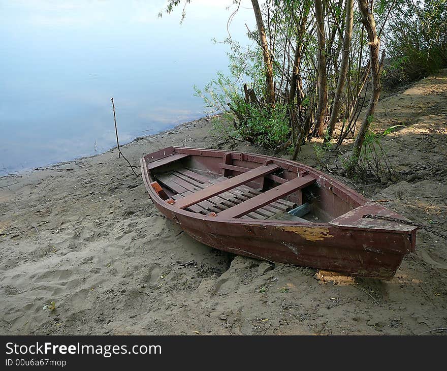 Old obsolete wooden boat on river coast. Old obsolete wooden boat on river coast