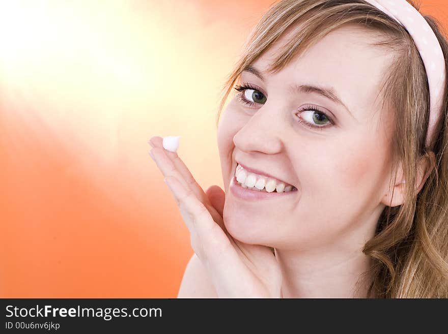 Portrait of beautiful smiling woman applying creme / Copyspace. Portrait of beautiful smiling woman applying creme / Copyspace