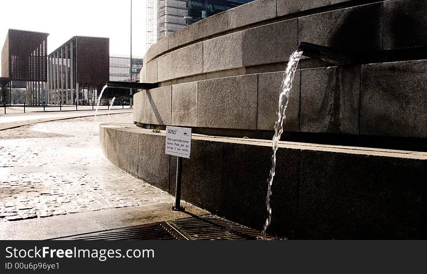 Water coming out of a public fountain on a sunny day in lisbon, portugal. Water coming out of a public fountain on a sunny day in lisbon, portugal