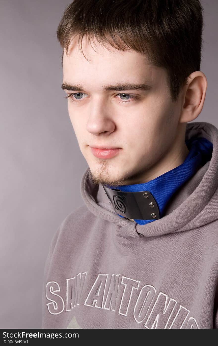 The young guy in studio on a grey background