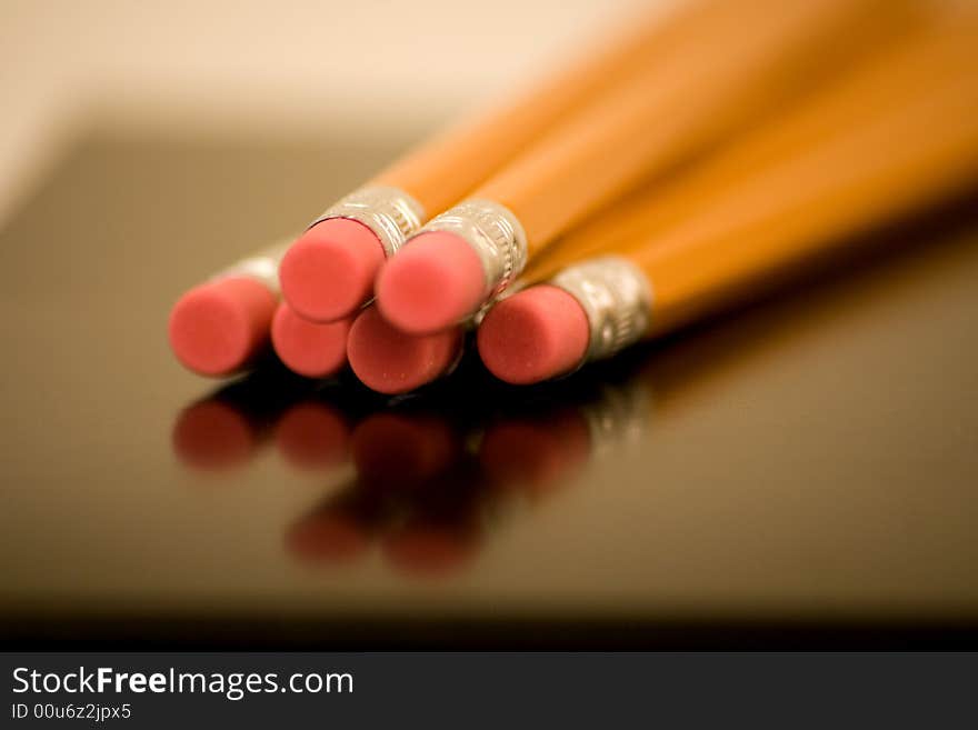 Erasers on Wood Pencils v1 are captured using depth of field with a reflection and nice perspective.