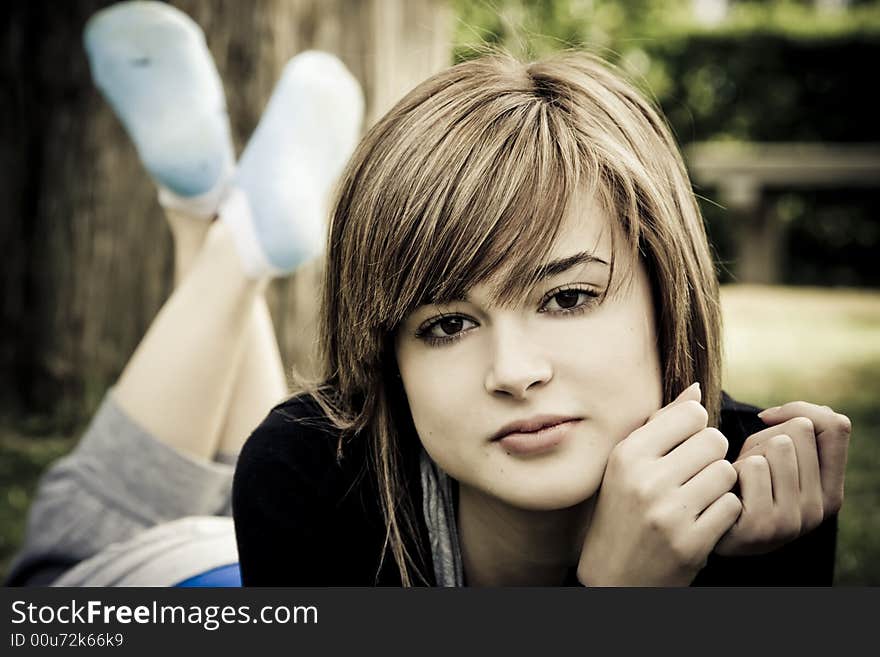 Beautiful young woman resting in the park. Beautiful young woman resting in the park.