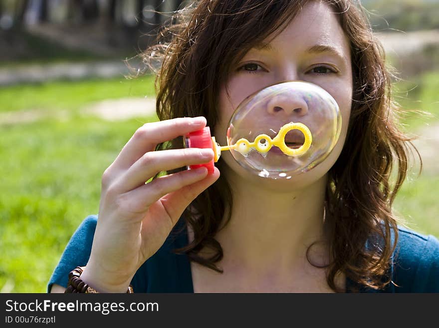 Red haired woman playing with bubbles