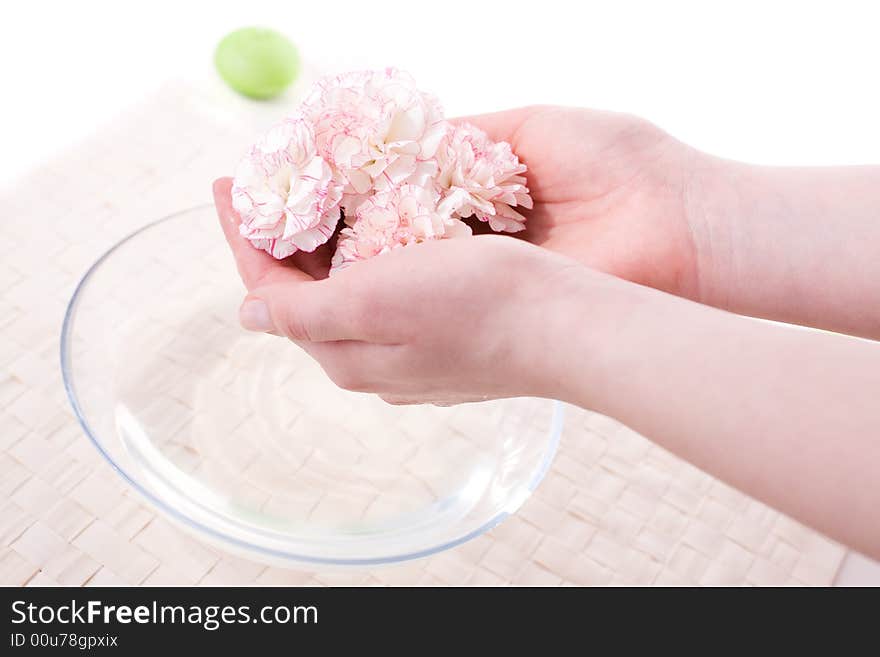 Female hands in bowl full of water