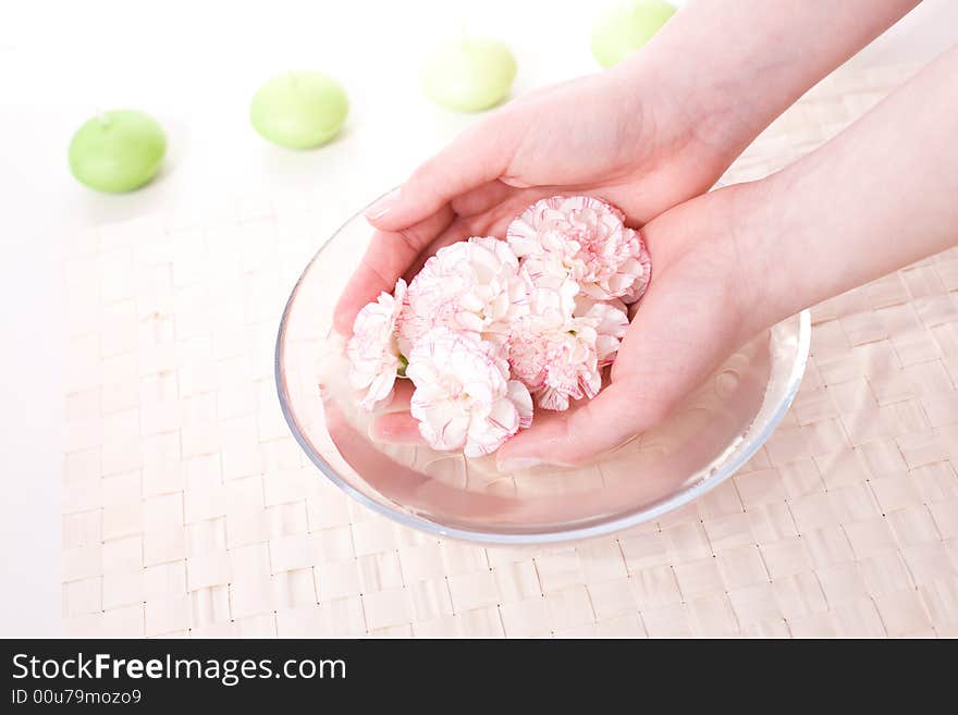 Female hands in bowl full of water