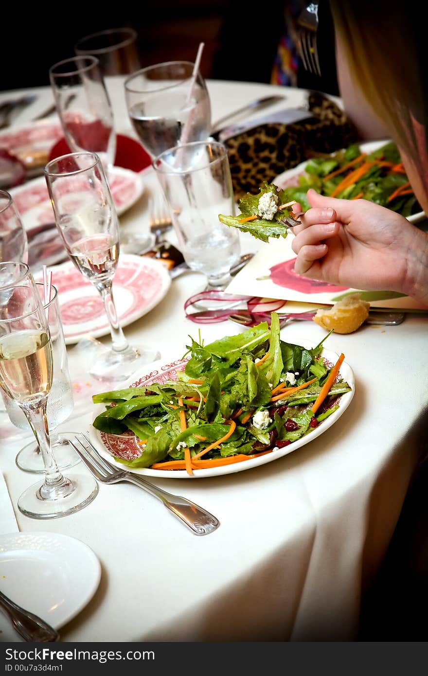 Salad is served during a wedding celebration. Salad is served during a wedding celebration