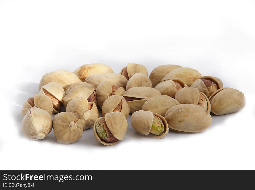 Opened pistachioes on white background