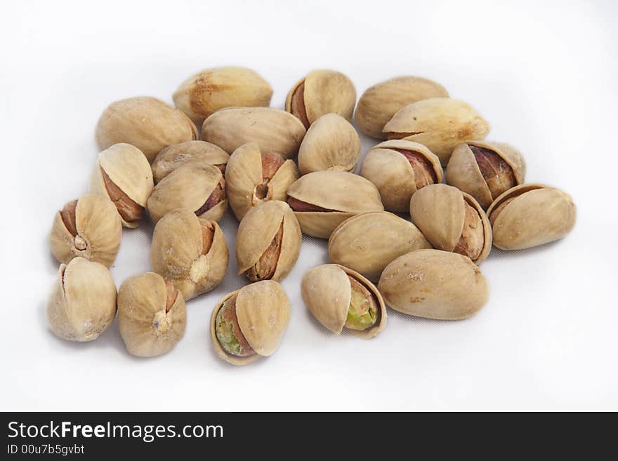 Opened pistachioes on white background