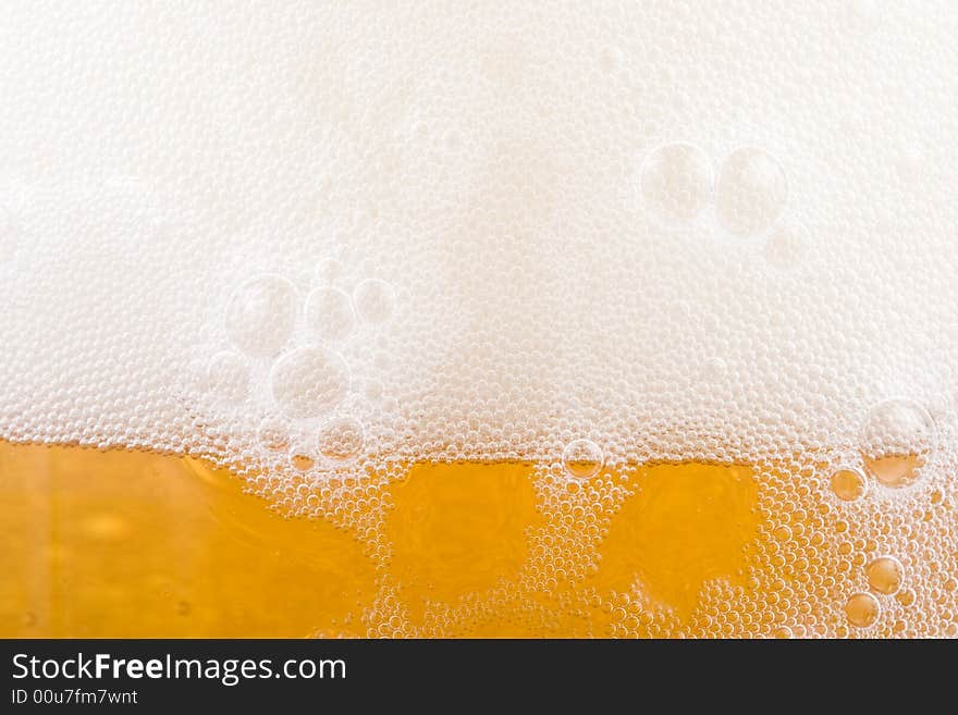 Background from fresh foamy beer with bubbles. Close-up. Background from fresh foamy beer with bubbles. Close-up.