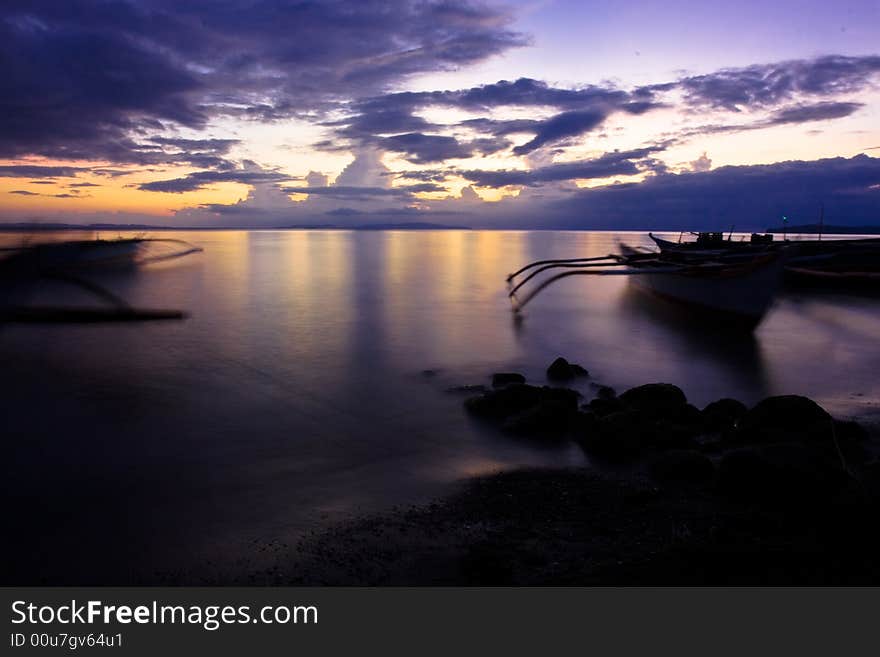 Banca boats on the beach at sunset. Banca boats on the beach at sunset