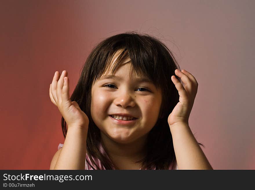 Young girl holding her hands in the air looking happy. Young girl holding her hands in the air looking happy