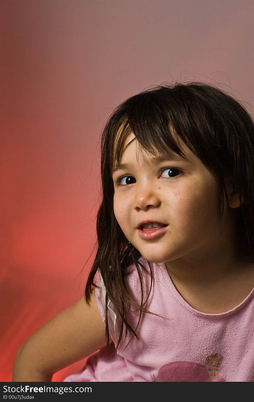 Young girl looks on shyly. Young girl looks on shyly