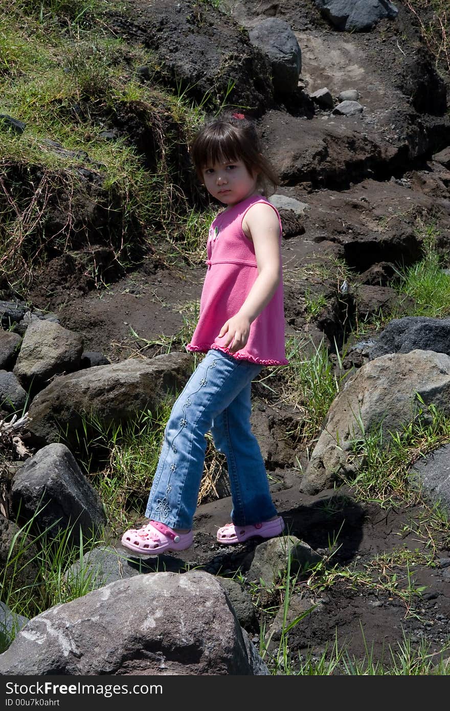 Girl walking on rocks