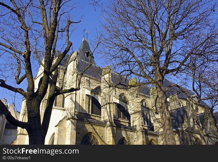 France; Paris; winter view with architecture; the St. Medare church and some bared trees. France; Paris; winter view with architecture; the St. Medare church and some bared trees