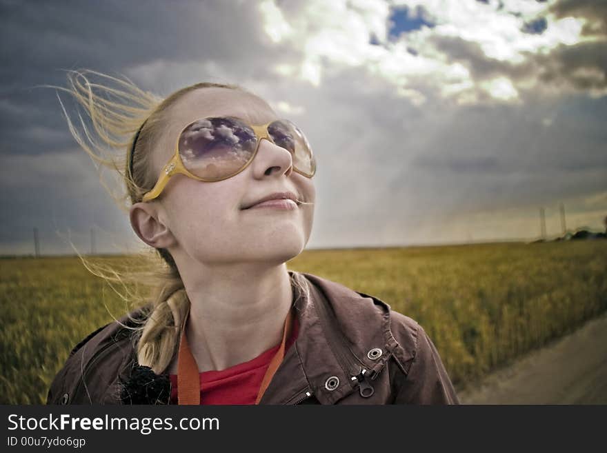 Outdoor portrait of young smiling blonde woman with sunglasses. Outdoor portrait of young smiling blonde woman with sunglasses